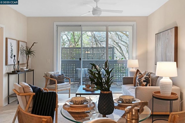 living room with ceiling fan and carpet flooring