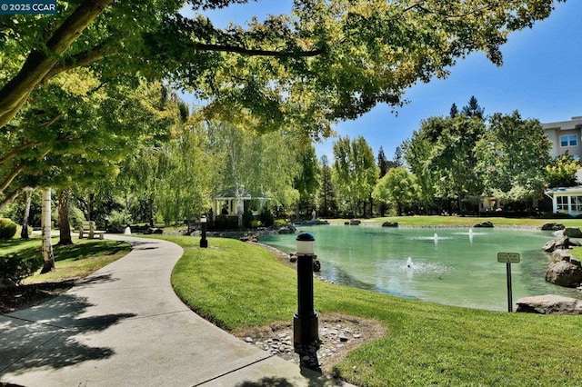 view of home's community featuring a water view and a yard