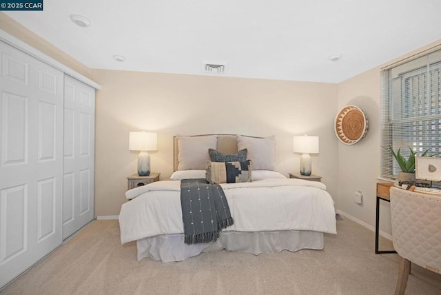 carpeted bedroom featuring a closet