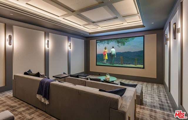 carpeted home theater featuring coffered ceiling