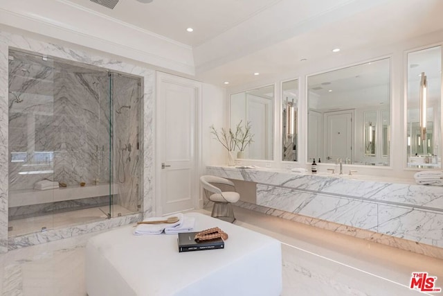 bathroom featuring a shower with shower door and vanity