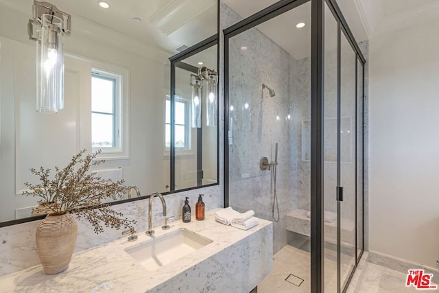 bathroom featuring sink, crown molding, and an enclosed shower