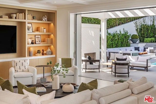 living room featuring a fireplace and built in shelves