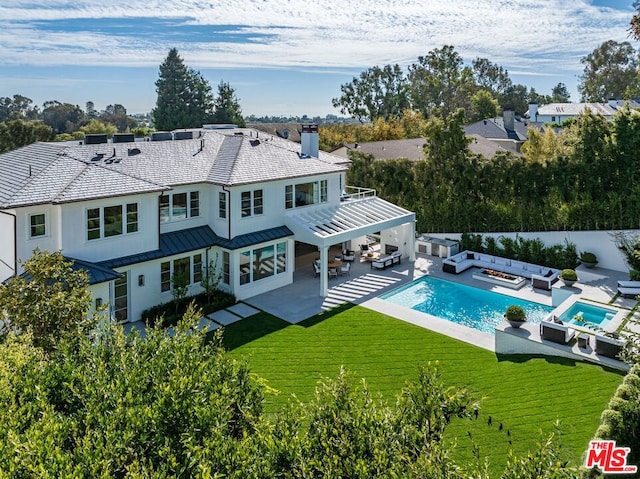 rear view of house with an outdoor hangout area, a lawn, a pergola, a fenced in pool, and a patio area