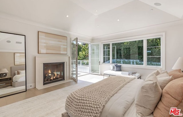 bedroom with ornamental molding, access to exterior, multiple windows, and light wood-type flooring