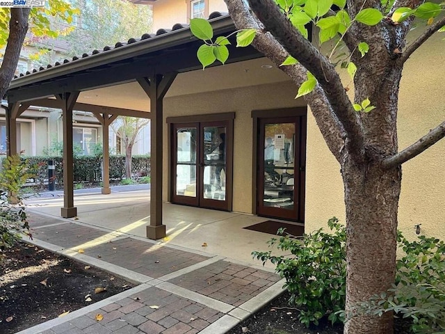 property entrance featuring french doors