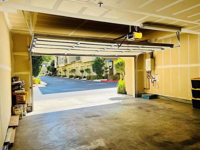 garage with water heater and a garage door opener