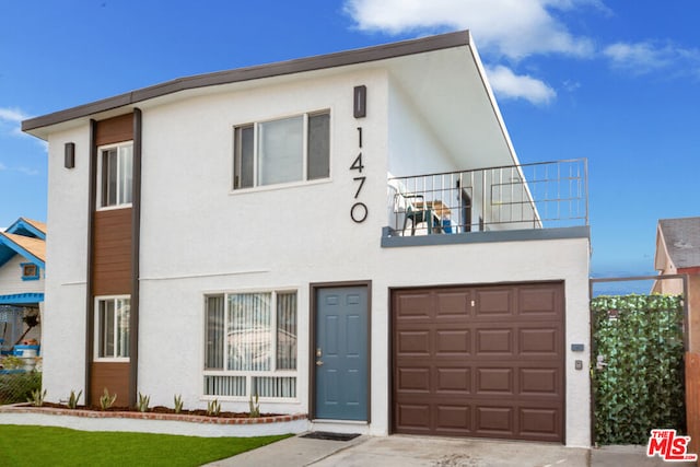 view of front of home with a balcony and a garage