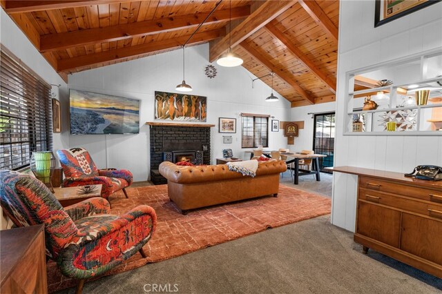 living room with wood ceiling, a brick fireplace, carpet floors, and beamed ceiling