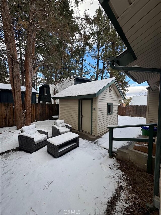 yard covered in snow featuring a storage unit