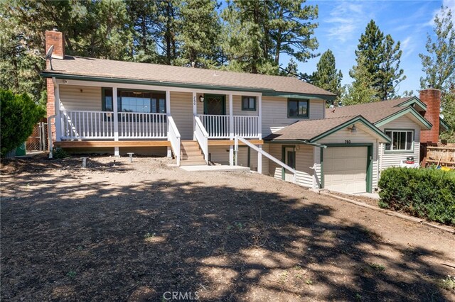 view of front of property featuring a porch and a garage