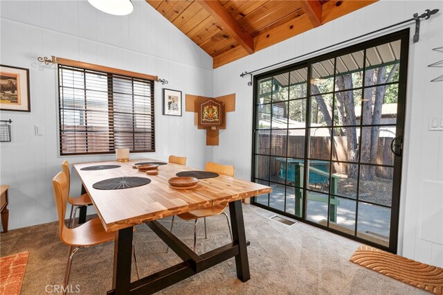 dining area with carpet flooring, vaulted ceiling with beams, and wood ceiling