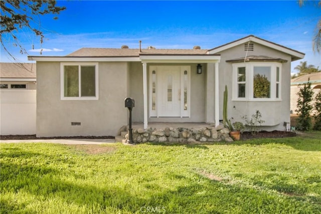 view of front of property featuring a garage and a front lawn