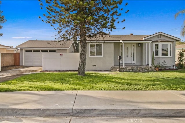 view of front of home with a front yard and a garage