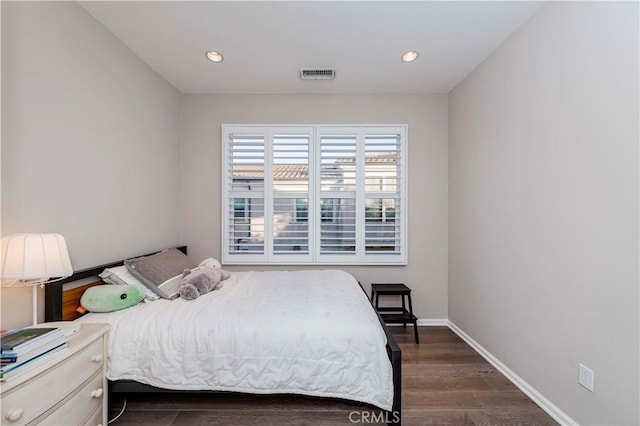 bedroom with dark hardwood / wood-style flooring