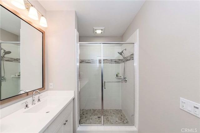 bathroom with an enclosed shower and vanity