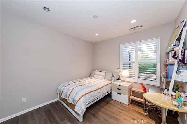 bedroom with hardwood / wood-style floors