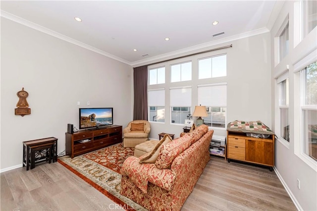 living room with light hardwood / wood-style flooring and crown molding