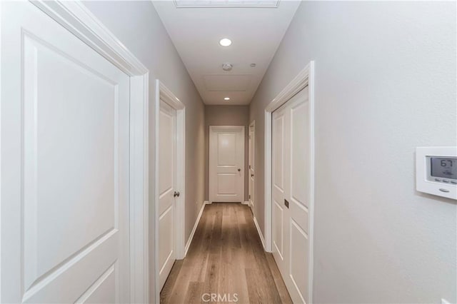 corridor with hardwood / wood-style floors