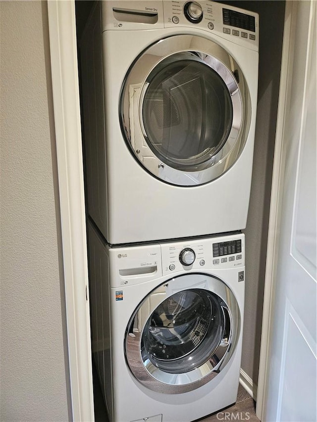 laundry room with stacked washer and clothes dryer