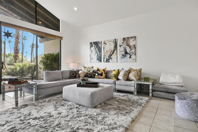 living room featuring lofted ceiling and light tile patterned floors