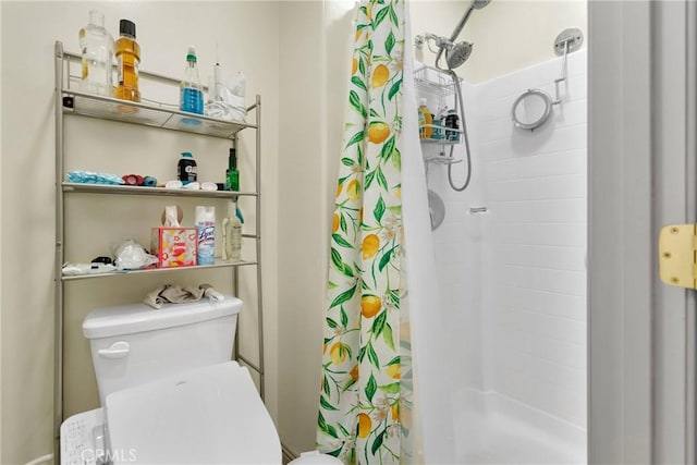 bathroom with curtained shower and toilet