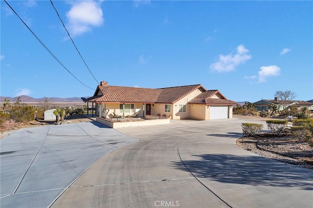32758 Spinel Rd, Lucerne Valley, CA 92356 - view of front of property with a tile roof, curved driveway, stucco siding, a garage, and a mountain view