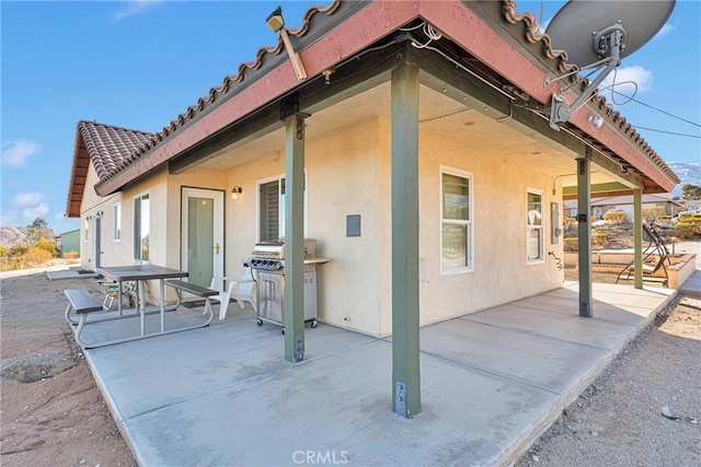 view of side of property featuring a patio area