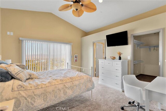 carpeted bedroom featuring lofted ceiling, a closet, ceiling fan, and a spacious closet