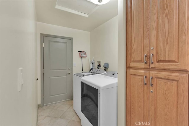 32758 Spinel Rd, Lucerne Valley, CA 92356 - clothes washing area with attic access, washing machine and clothes dryer, cabinet space, and light tile patterned floors