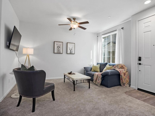 carpeted living room featuring ceiling fan