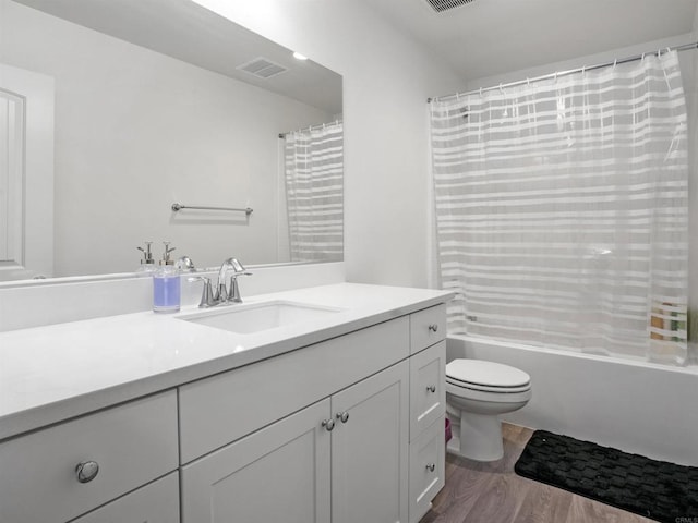 full bathroom featuring shower / bath combo, toilet, vanity, and hardwood / wood-style flooring