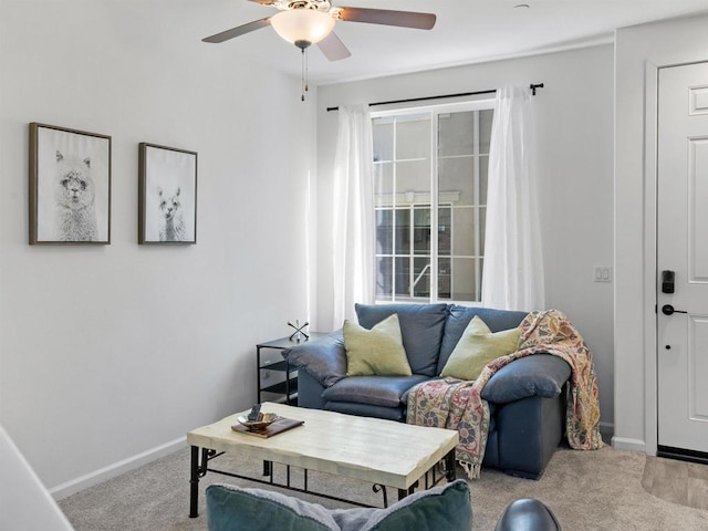 carpeted living room with ceiling fan