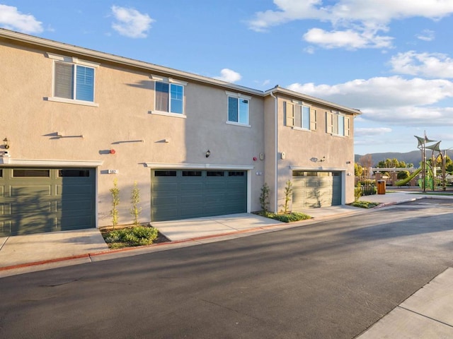 view of front facade with a mountain view and a garage