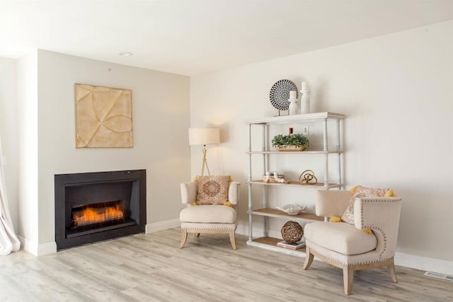 sitting room featuring light hardwood / wood-style flooring