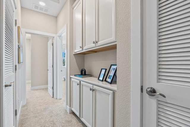 corridor with light colored carpet