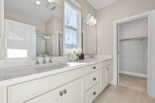 bathroom featuring walk in shower and vanity