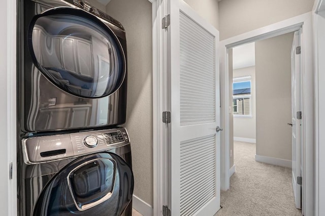 clothes washing area with light carpet and stacked washer and clothes dryer