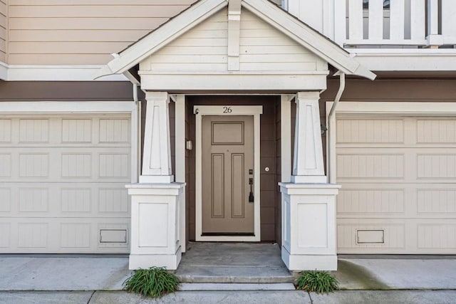 view of exterior entry featuring a garage