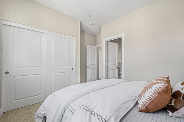 carpeted bedroom with a closet