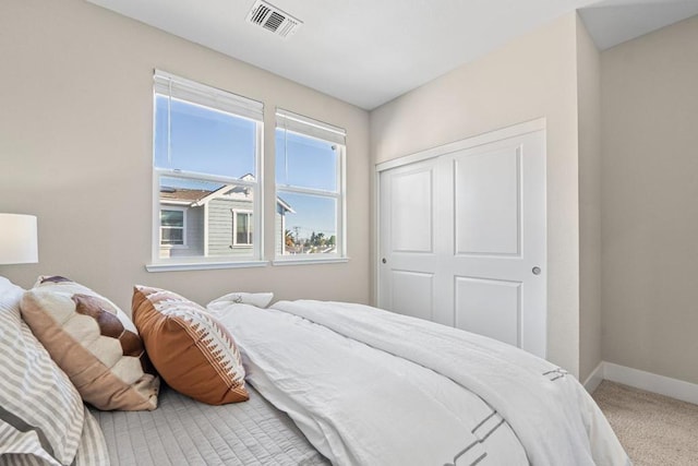 carpeted bedroom with a closet