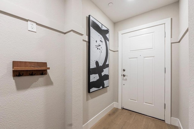 doorway to outside with light wood-type flooring