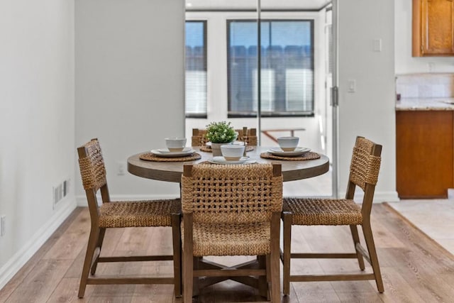 dining area with light hardwood / wood-style floors