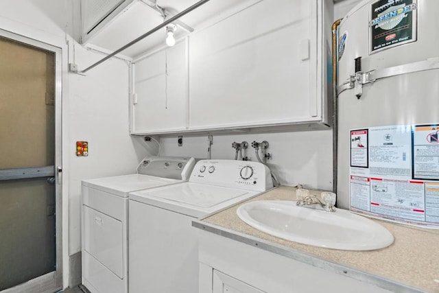 laundry room with washing machine and dryer, secured water heater, and sink