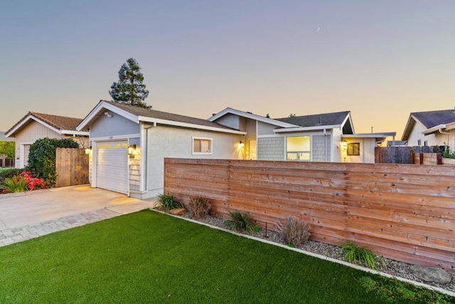 view of front of house featuring a yard and a garage