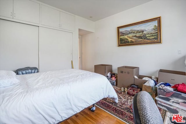 bedroom featuring hardwood / wood-style flooring and a closet