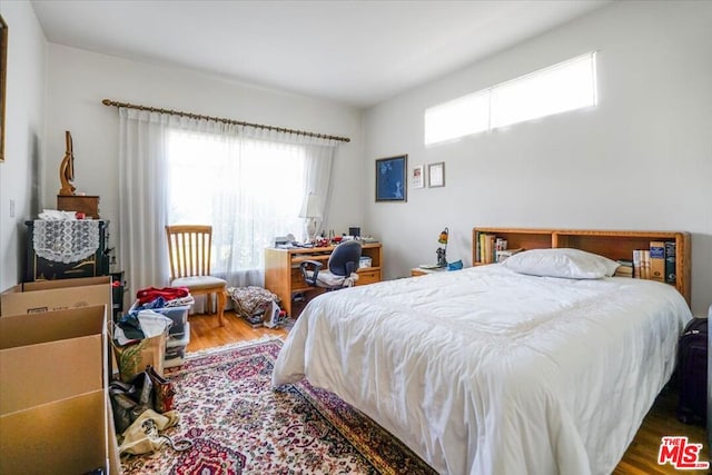 bedroom with hardwood / wood-style floors