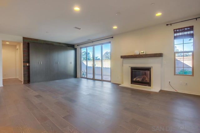 unfurnished living room with dark hardwood / wood-style flooring