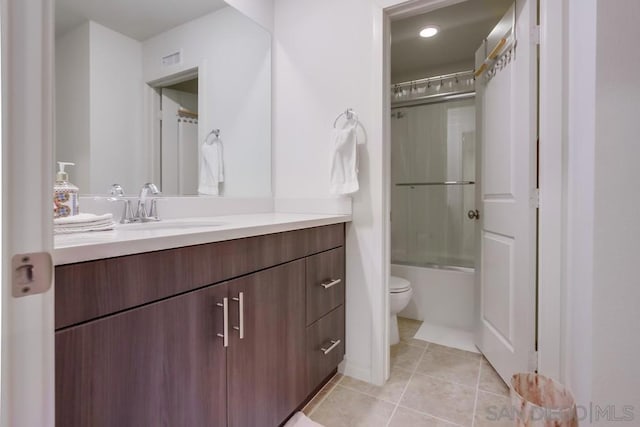 full bathroom featuring shower / bath combination with glass door, toilet, tile patterned floors, and vanity