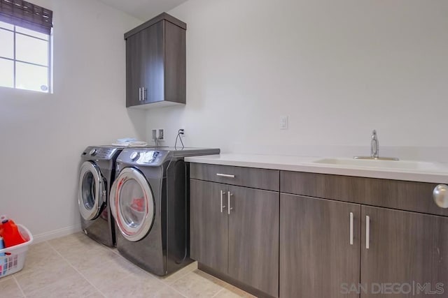 washroom featuring sink, cabinets, washer and clothes dryer, and light tile patterned flooring